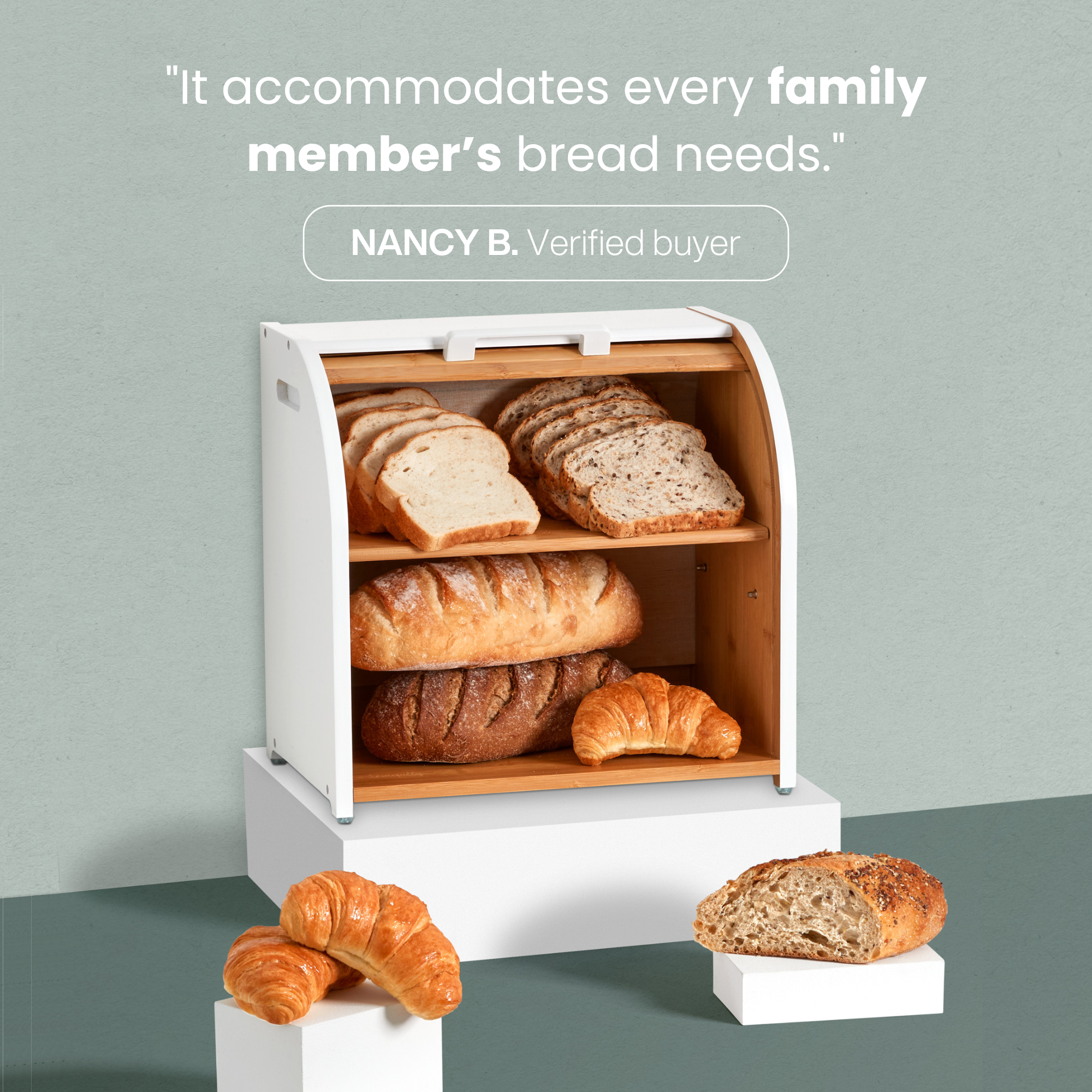 Kitchen counter with a breadbox, mugs, and decorative items.