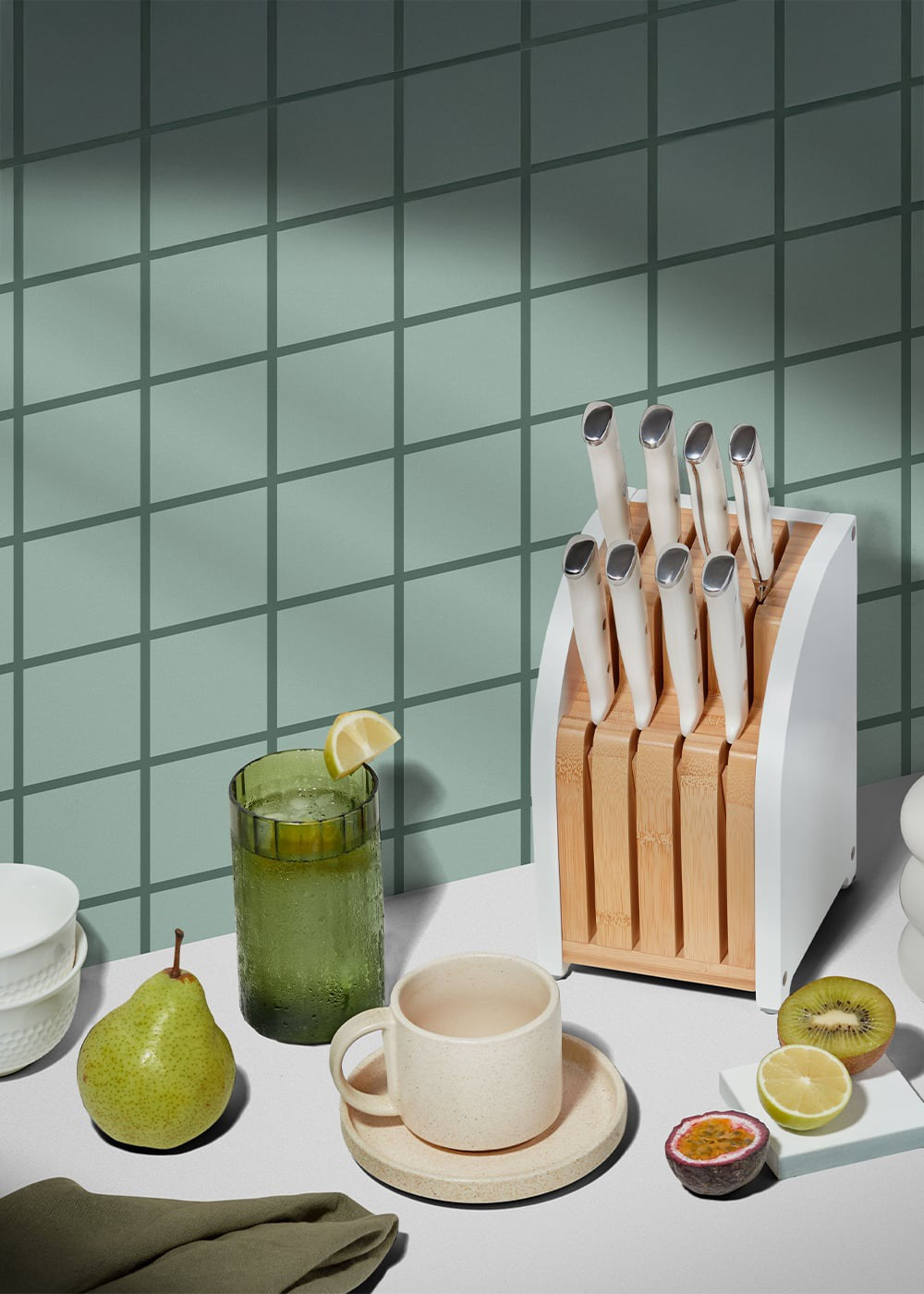 Kitchen counter with a breadbox, mugs, and decorative items.