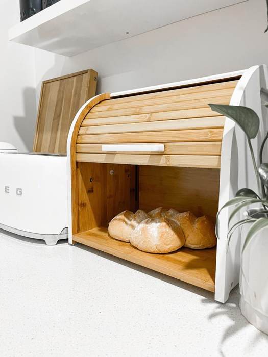 Bread box with loaves on a white kitchen bench