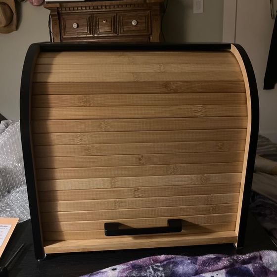 Black bread box on a bench