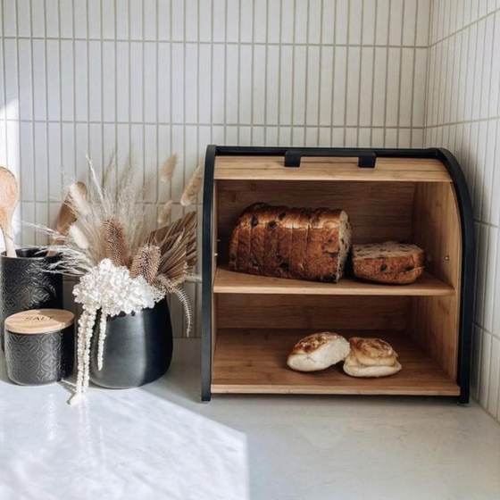 Black bread box with loaves, styled with flowers