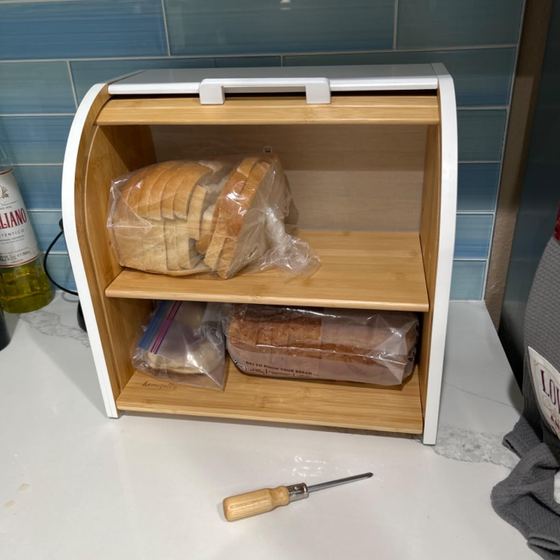 Open bread box with bread and the screwdriver